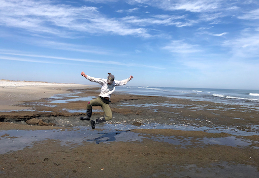a person jumping for joy on beach