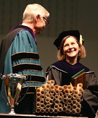 VIMS Professor Elizabeth Canuel (right) shares a laugh with W&M President Taylor Reveley during the 2014 commencement exercises at W&M. Photo by Stephen Salpukas.
