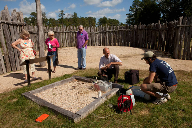 Doug Rowland '12 (R) and geologist Greg Hancock pump water from a well at Jamestown Fort.