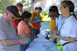 Barb Rutan (R) assists in the Children's Pavilion during Marine Science Day.