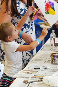 Younger guests created colorful fish prints at the arts and crafts section. Photo by Susan Maples/VIMS.