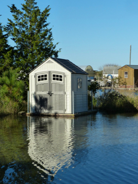 An amphibious shed rises with floodwaters in the VIMS Boat Basin.