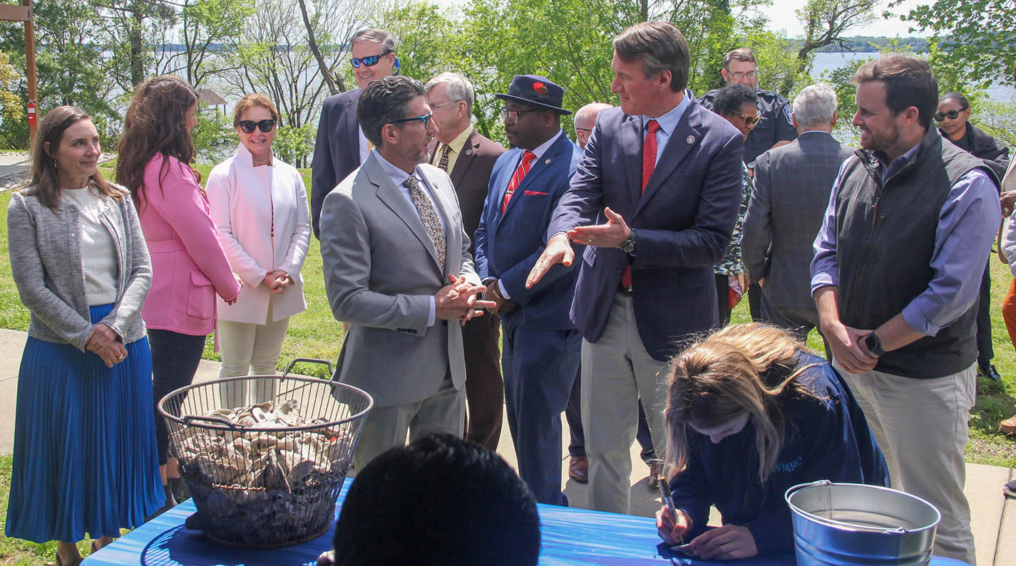 VIMS Dean and Director Derek Aday, Governor Glenn Youngkin, and officials from the Virginia Marine Resources Commission, National Oceanic and Atmospheric Administration, and others celebrate the York River oyster restoration milestone.