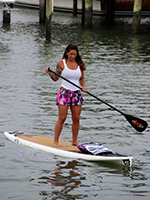 A stand-up paddle boarder gets ready to compete in the 2014 Coastal Run.