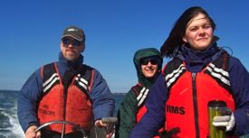 VIMS professor Emmett Duffy (L) with graduate students Rachel Blake and Althea Moore on the York River. Photo by Paul Richardson.