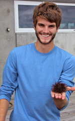 VIMS Volunteer Tim Beck poses with a sea urchin from one of the touch-tanks available during Marine Science Day.