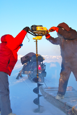 Deborah Bronk and a colleague drill through sea ice on the Chuckchi Sea to take water samples.