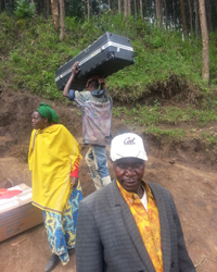 Local Rwandans help move the first delivery of equipment up the summit of Mt. Karisimbi.