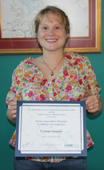 OAT Graduate Cyrene Grover proudly poses with her oyster aquaculture certification.