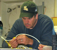 John  Pohlman prepares sampling equipment in a shipboard lab during the study of gas hydrates.