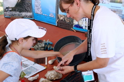 Karen Hudson shows oyster spat to a young visitor during the Smithsonian Institution's annual Folklife Festival on the National Mall in Washington D.C. in 2007.