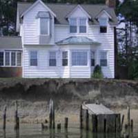 House threatened by erosion because shore protection failed