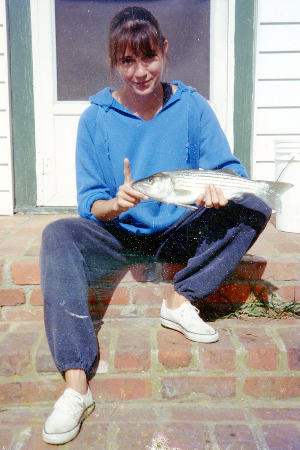 Baldwin as a graduate student, displaying a striper from the York River. Photo provided by Carole Baldwin.