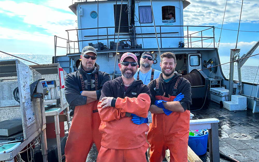 Gartland (center) aboard a research vessel with fellow researchers.