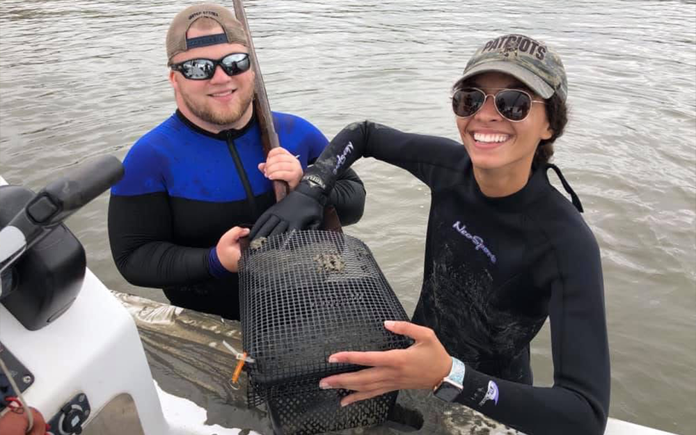 Landry and her husband deploying cages as part of Landry's thesis project.