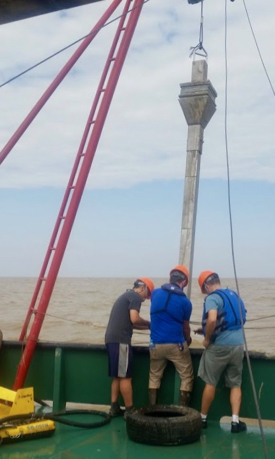 Members of the research team retrieve a core from the bottom sediments of the Andaman Sea off Myanmar's Irrawaddy-Salween Delta.