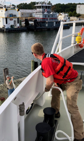 Mate Taylor Moore (R) deploys a docking line while marine safety officer Jim Goins assists. Home port for the R/V Virginia is the Ampro Shipyard on the Rappahannock River.