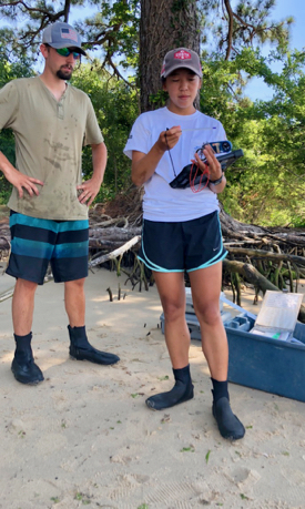 Field assistants Matt Oliver and Emelia Marshall prepare to measure water temperature and salinity at their sampling site for juvenile striped bass on the James River. © D. Malmquist/VIMS.