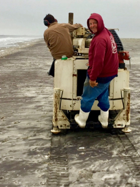 Sean Fate catches a ride on Christopher Hein's GeoProbe rig during field work on the Eastern Shore.