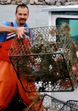 Dave Stanhope, CCRM research manager, handles a derelict or “ghost” crab pot recovered from the York River. © D. Malmquist/VIMS.