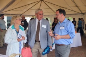 VIMS professor Rob Latour (R) discusses use of the RV {em}Virginia{/em} by his Multispecies research group with VIMS Foundation Board member David Nelson Meeker (C) and his spouse Becky in the Science tent on the Yorktown waterfront prior to the christening.  © C. Katella/VIMS.