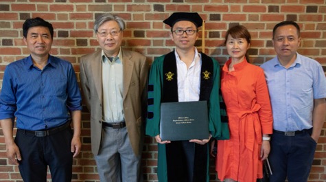 Celebrating commencement with Dr. Qubin Qin (holding diploma) are (from L) his father Zhaohui Qin, his Ph.D. advisor Dr. Jian Shen, his mother Xiaohong Ni,  and his uncle Weidong Ni. Qin's family traveled to the ceremony from Anhui province, China. © N. Meyer/W&M.