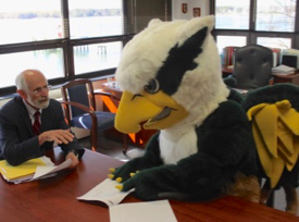 Wells enjoys some light-hearted fun with the university mascot.