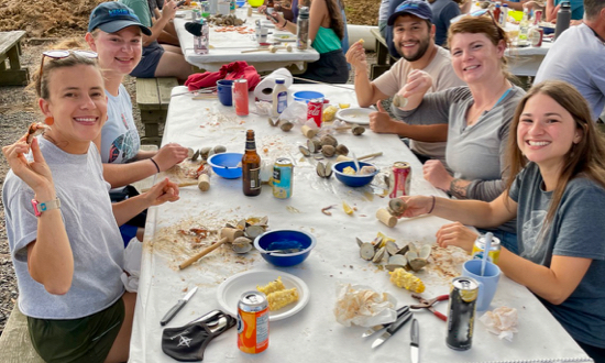 MA student Rachael King (2nd from L) joins fellow students for the traditional seafood feast during the annual new-student field trip to VIMS’ Eastern Shore Laboratory. Clockwise from L: fellow MA student Kati McCarter, King, PhD student Miguel Montalvo Camacho, MS student Sarah Koshak, and fellow MA student Anna Caputo. © J. Griffin/VIMS.