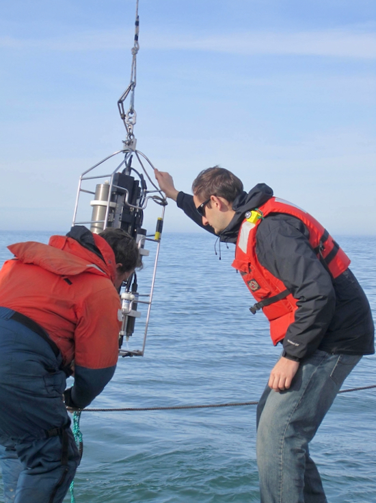 Lead author Piero Mazzini (R) measures ocean conditions during a previous field project.