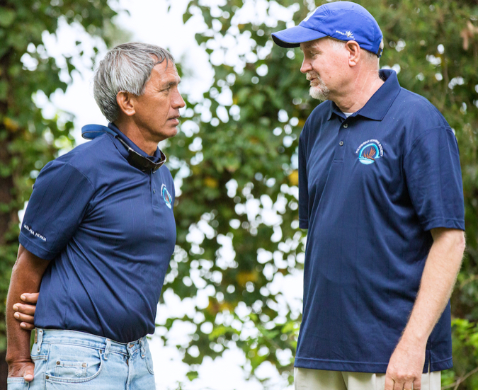 VIMS professor Kirk Havens (R) speaks with long-time friend Nainoa Thompson during the Hokuleʻa’s 2016 voyage around the Chesapeake Bay. © J. Michael Foreman.
