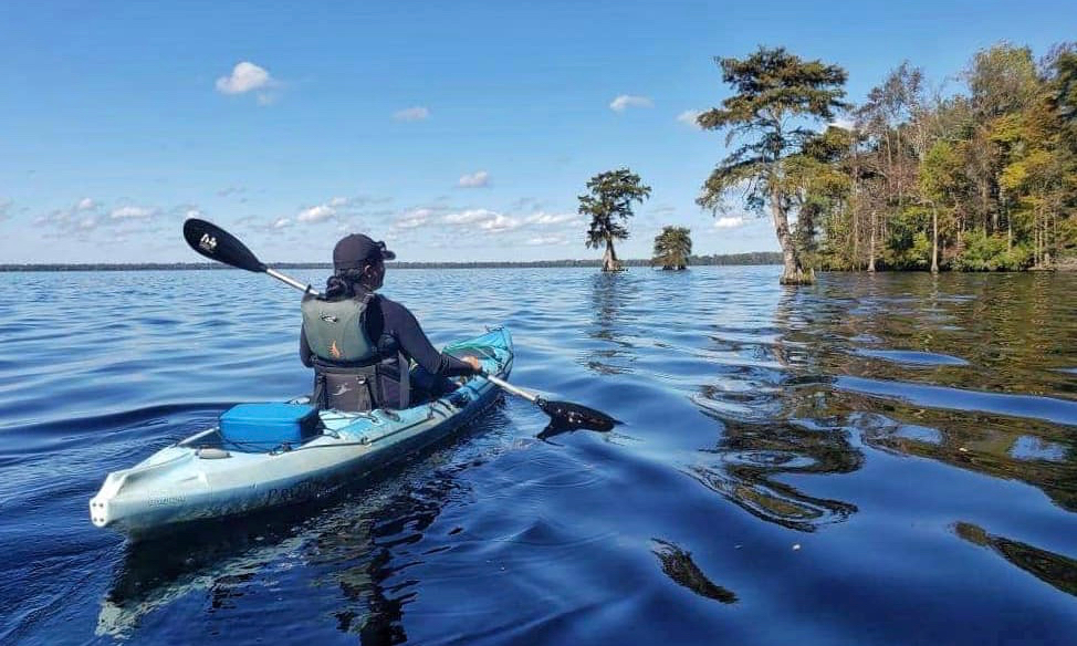 Nikki Bass, a Tribal Councilwoman of the Nansemond Indian Nation of the southern Chesapeake Bay, paddles her kayak across Lake Drummond in Virginia.