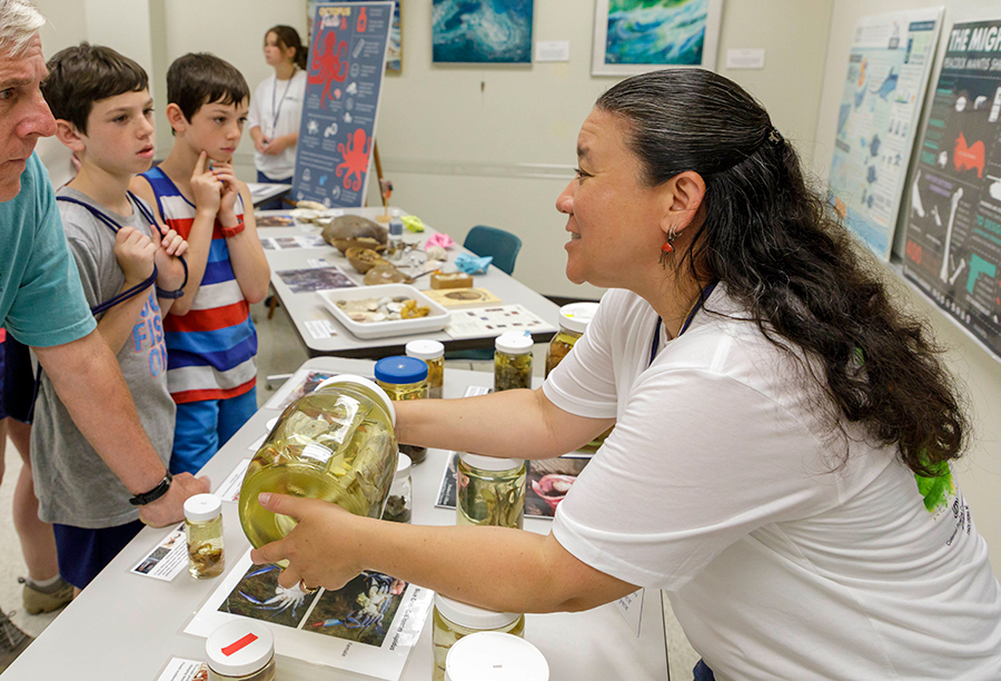 Jenny Dreyer presenting preserved invertebrate specimens to guests on Marine Science Day, 2023.  Photo credit: Lathan Goumas