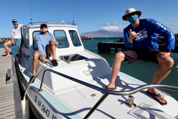 From L: Researchers Kevin Weng, Alan Friedlander, and Russell Sparks aboard the State of Hawai'i research vessel {em}Keolahoa{/em}. © Whitney Goodell/ National Geographic.