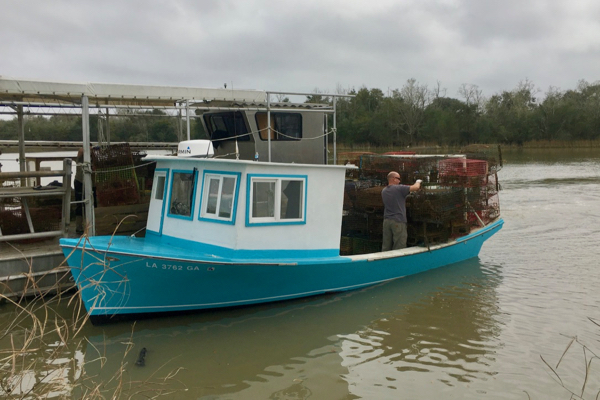 A Louisiana crab boat returns to the dock with a load of recovered derelict crab traps. © VIMS.