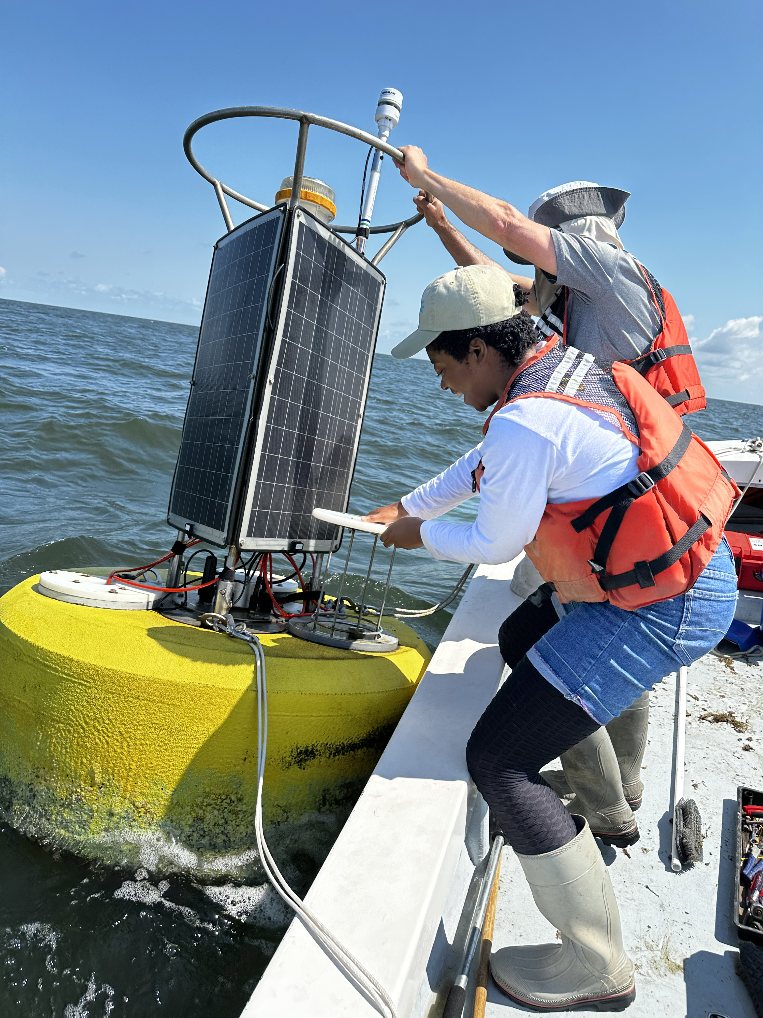 Grand Prize Winner Kaitlyn Parker, CBNERR-VA Laboratory & Field Research Specialist, took home the grand prize this year in VIMS' annual photo contest for her photo from the field: Retrieving a YSI EXO from Buoy. © Kaitlyn Parker