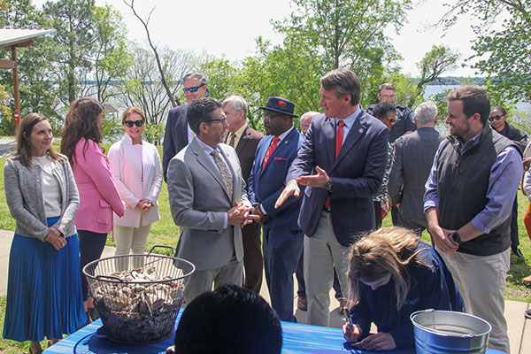 VIMS Dean and Director Derek Aday, Governor Glenn Youngkin, and officials from the Virginia Marine Resources Commission, National Oceanic and Atmospheric Administration, and others agencies celebrate the York River oyster restoration milestone.