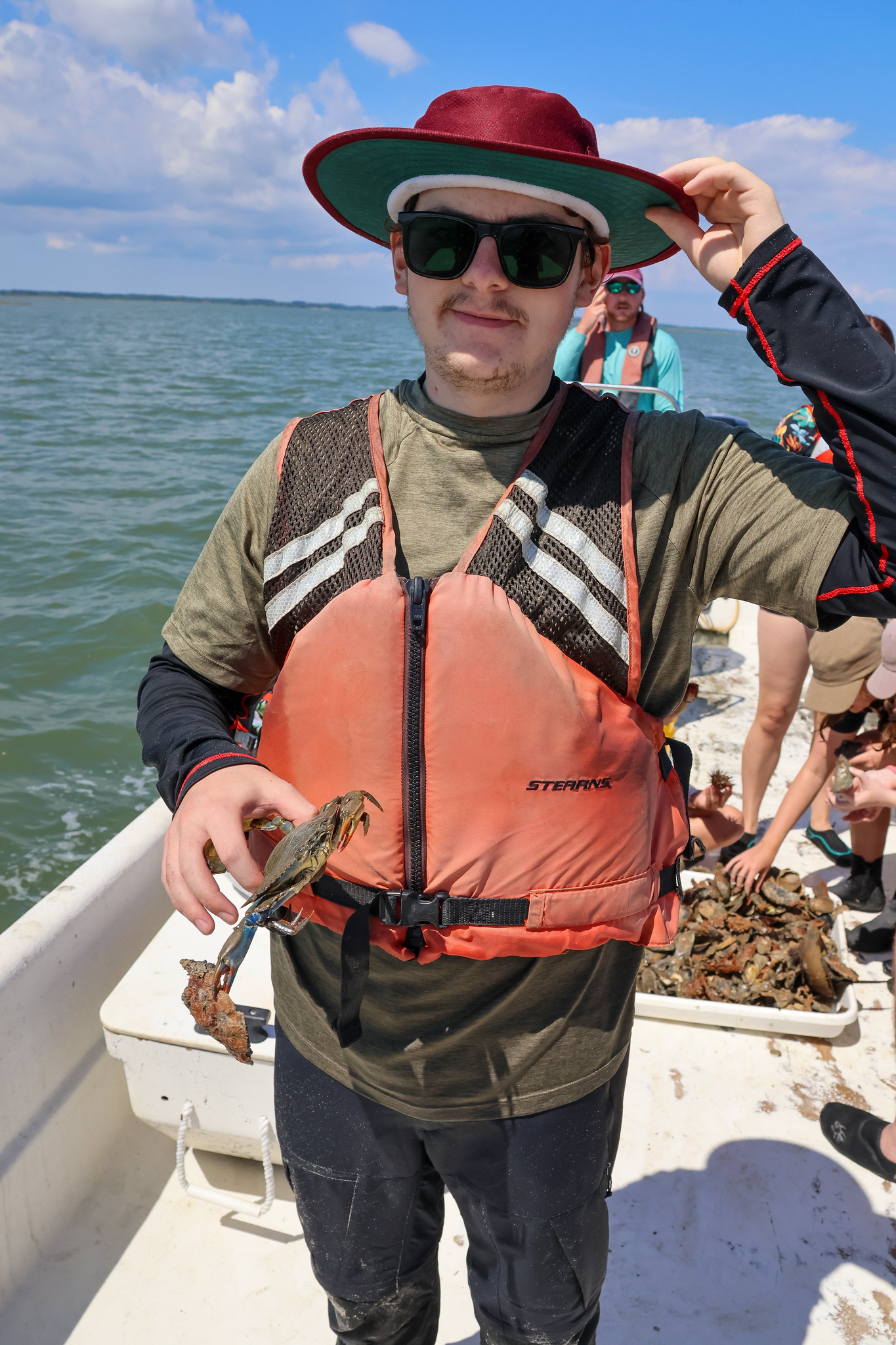 Bangor University student James Cox holds Blue Crab pulled up during dredge off Eastern Shore.