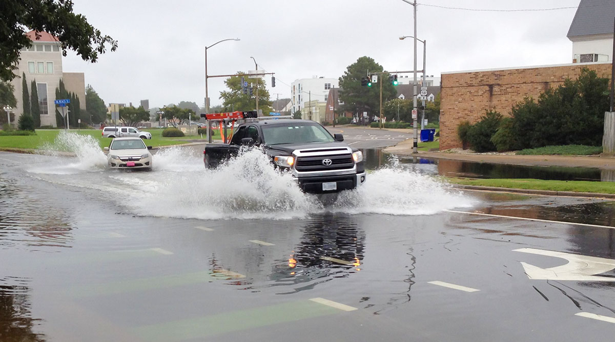 Drivers in Hampton Roads, Virginia, navigate tidal flooding. Tools such as StormSense and TideWatch can help communities prepare and plan around flooding events. Photo by Derek Loftis.
