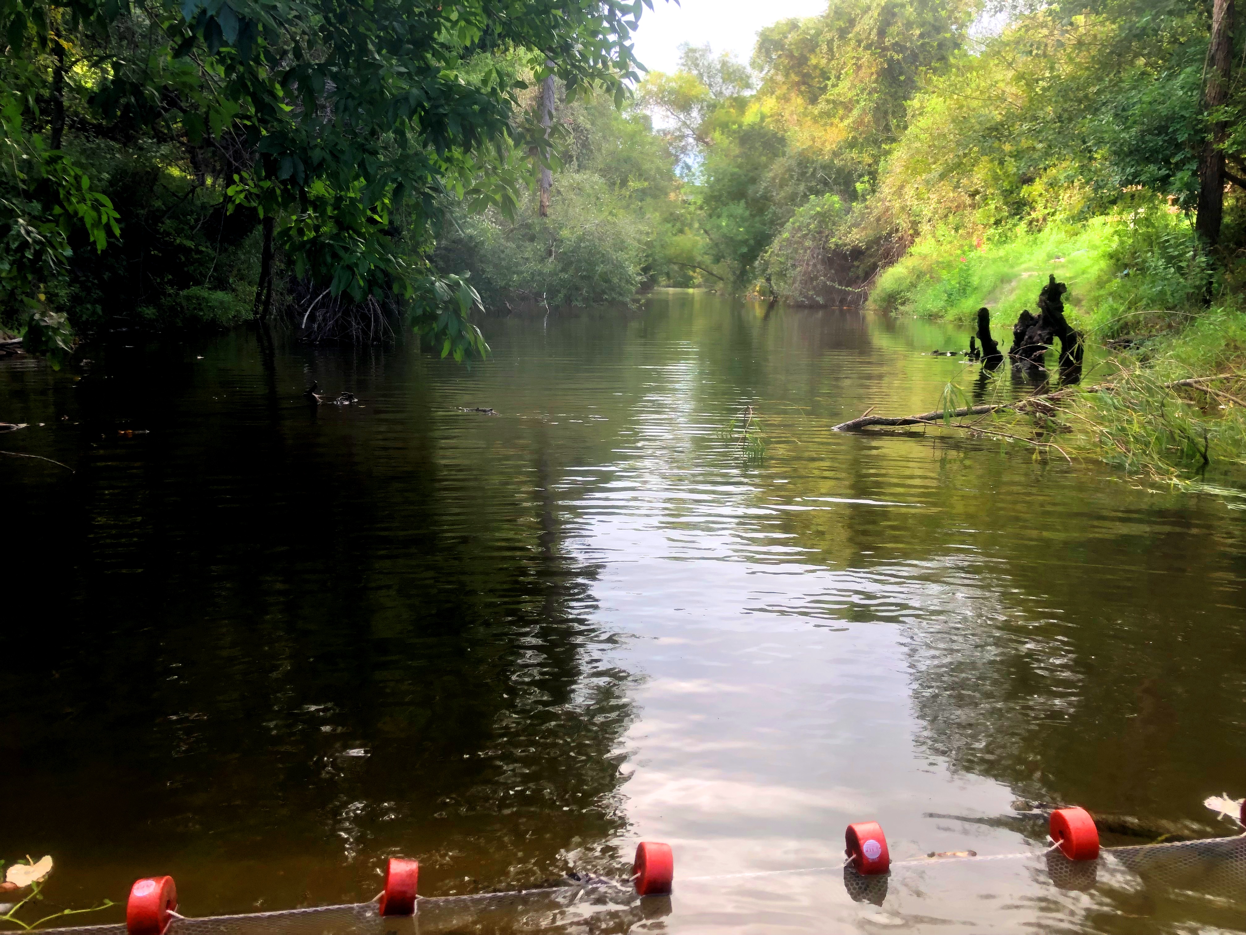 River in South Texas with net set up for fish sampling.