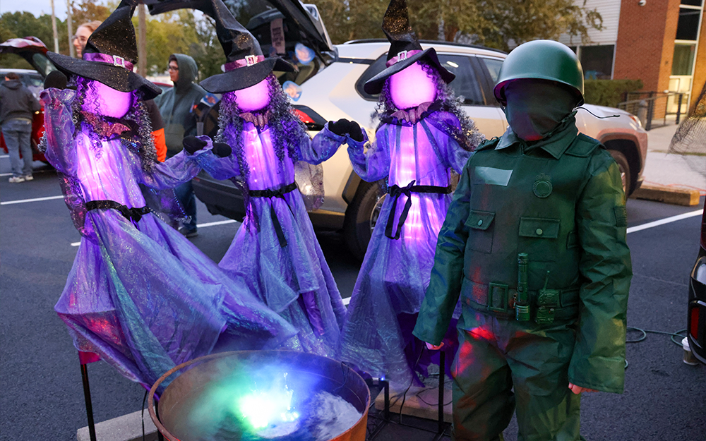 One costumed attendee posing with a trio of "sea witches."