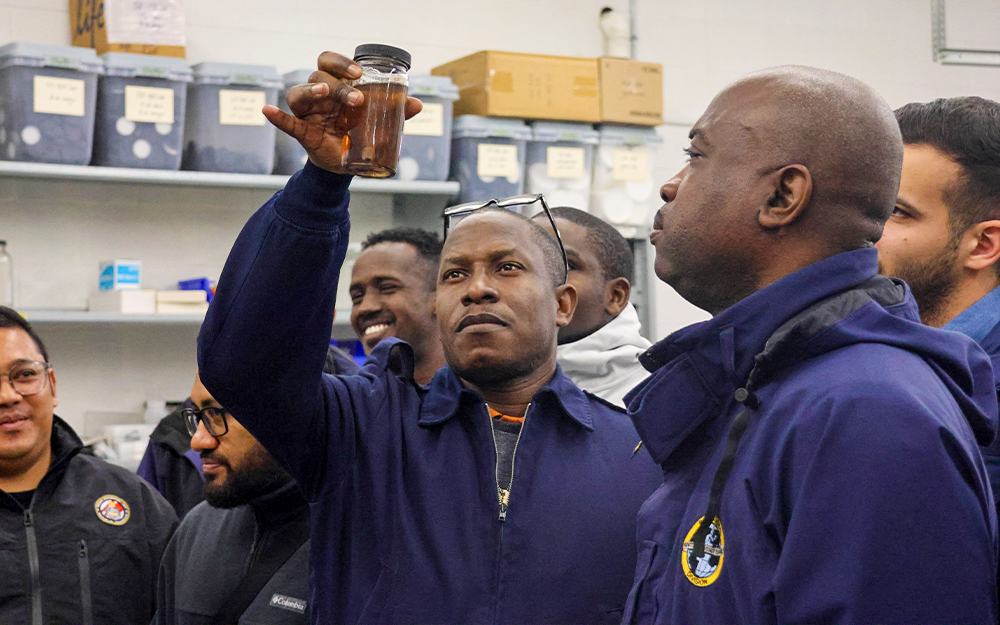 A USCG IMOC participant examines a preserved marine specimen in the Nunnally Ichthyology Collection. Photo by Candace Johnson.