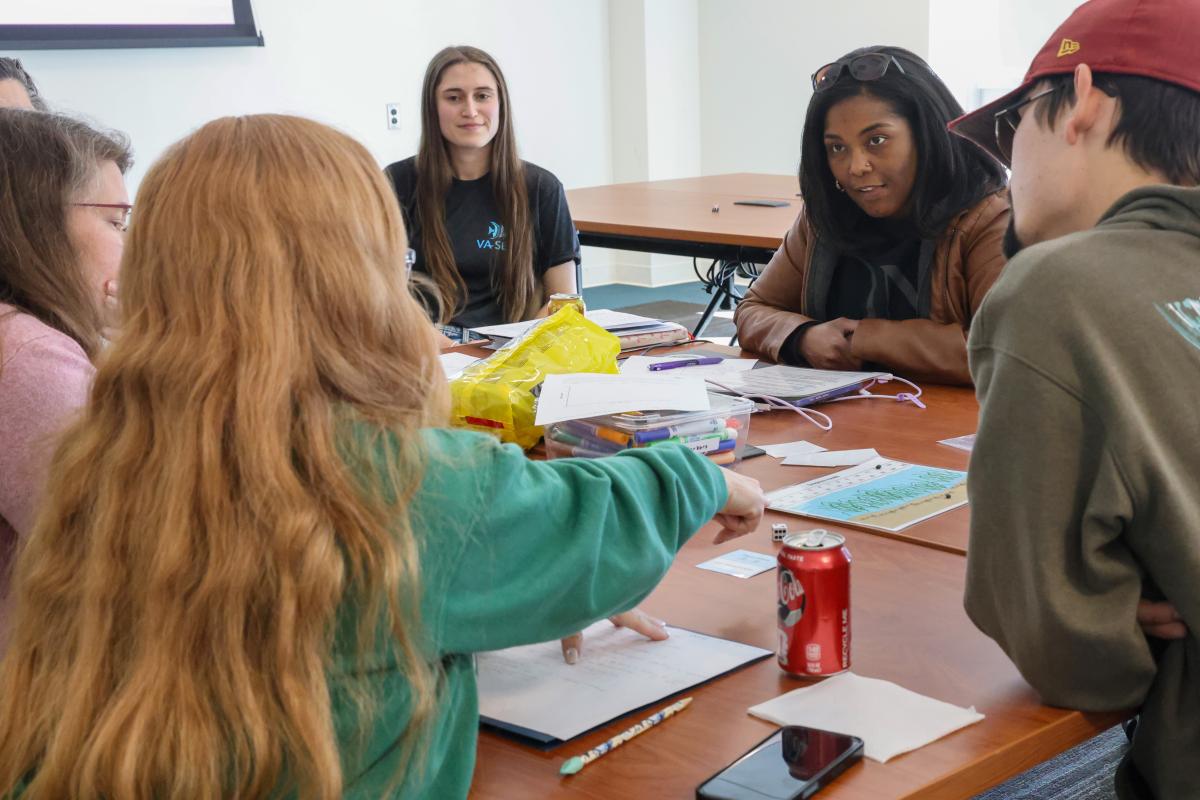 Virginia educators discuss a draft lesson plan designed by Batten & VIMS graduate student and VA SEA participant, Robyn Dudrick (center)