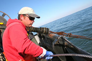 Crew member Stevie Ruhle of the Darana R deploys the net during the NEAMAP Trawl Survey.