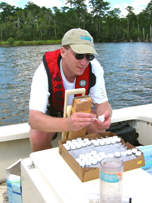 Dr. Brush samples nutrients from the New River Estuary, NC, as part of a project funded by the Department of Defense.