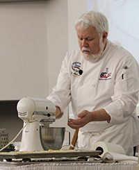 Chef John Maxwell gives a red crab cooking demonstration during the Chef's Seafood Symposium at VIMS.