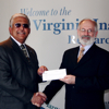 Alexander Smith of Dominion (L) presents a $50,000 check to VIMS Dean and Director John Wells. The gift will be used to equip a classroom in VIMS' new research building, Andrews Hall, which is scheduled to open in spring 2007.