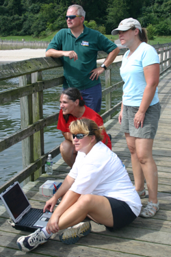 Sherry Rollins (Page Middle, in red), Sara Chaves Beam (CBGS, in white), and  Judy Gwartney-Green (Page Middle, in blue), pilot the remotely operated vehicle Fetch as VIMS professor Mark Patterson looks on.