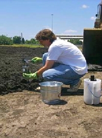 Professor Rob Hale takes a soil sample to help in his study of biosolids.