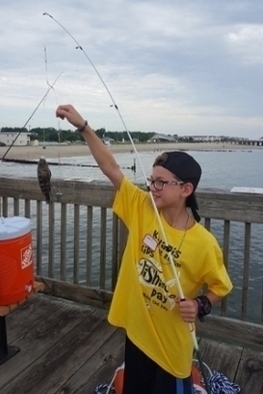 Colby Tubbs from Gloucester, VA holds up his 7 inch black sea bass. Photo: S. Musick/VIMS