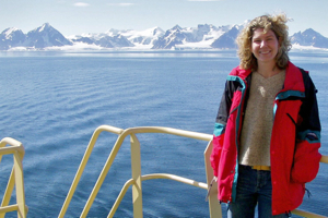 Dr. McCallister poses in front of the British Antarctic Survey's Rothera Research Station on Adelaide Island during a research cruise to Antarctica.